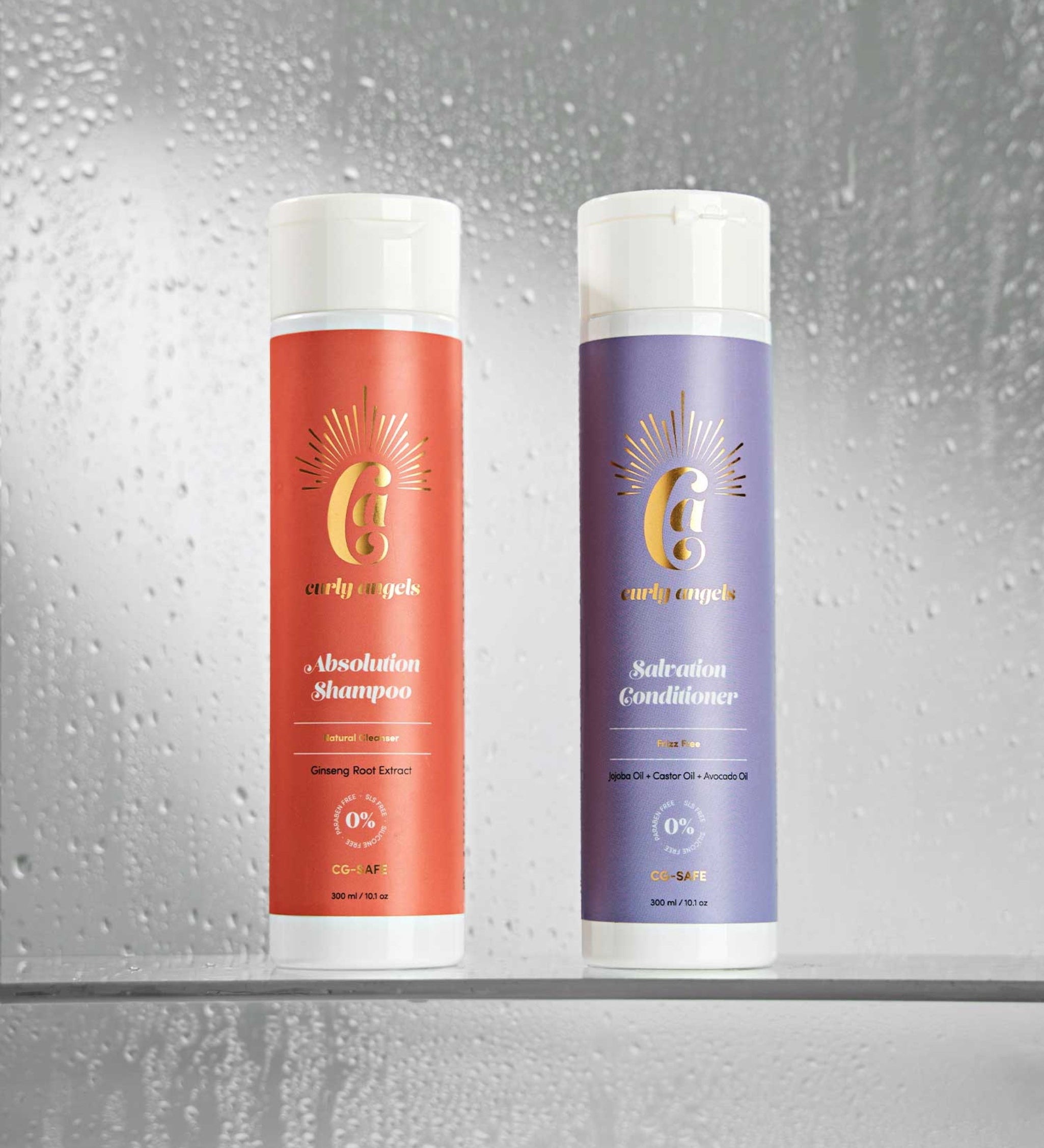 Curly Angels Salvation Conditioner picture atop stacked marble with two purple flowers balanced against it