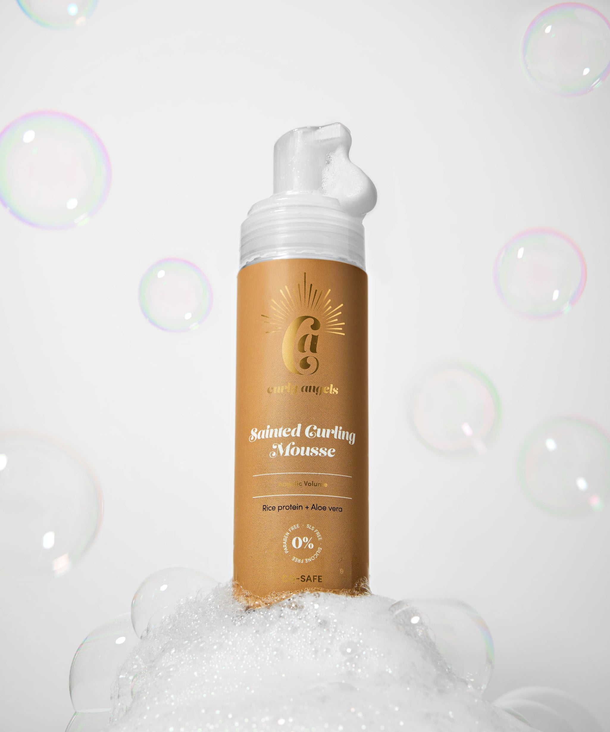 Curly Angels Sainted Curling Mousse against golden fabric backdrop