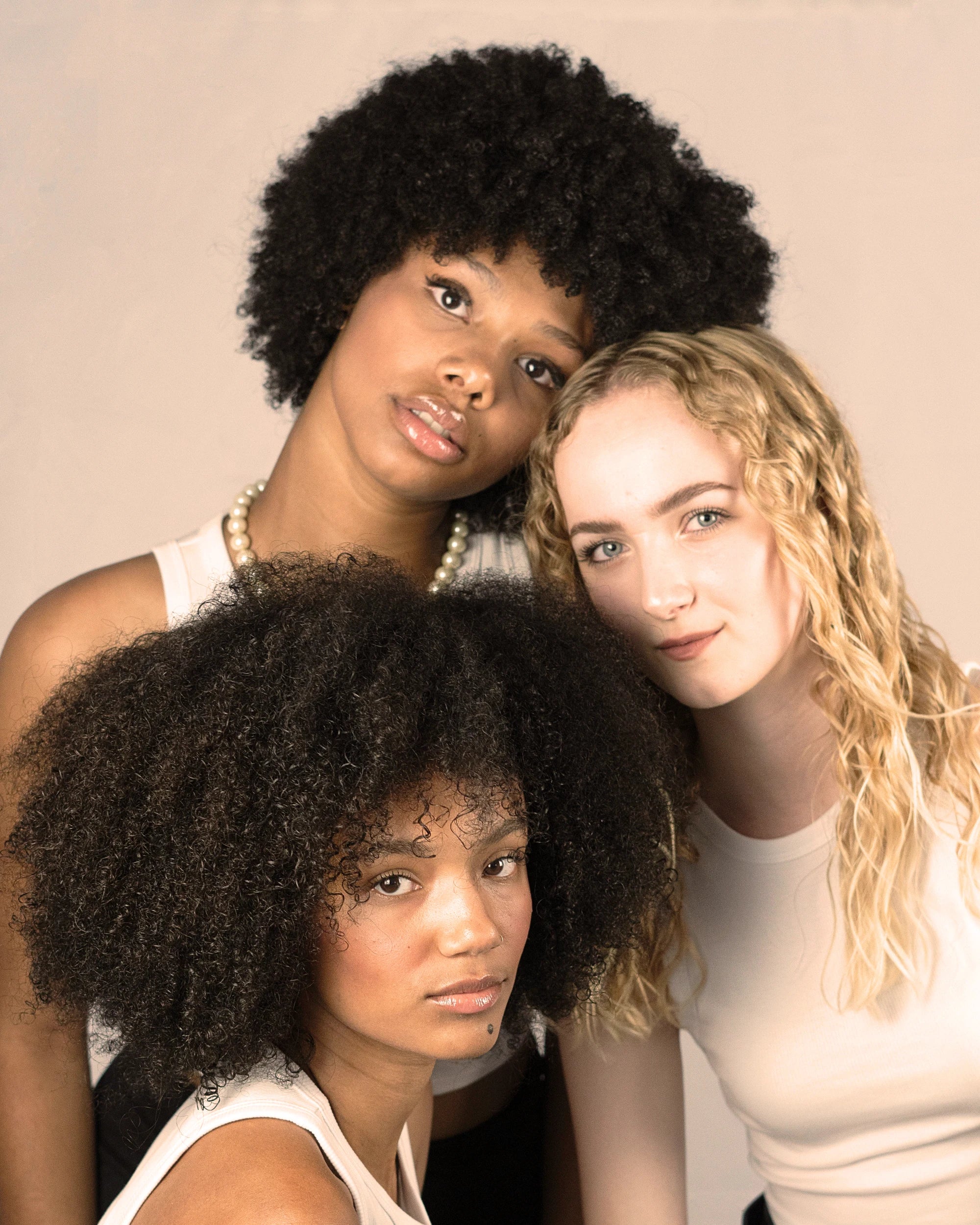 Curly Angels image depicting three models with curly hair - each model has a different curl type