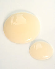 Curly Angels Holy Hold Styling Gel in two droplets on white background