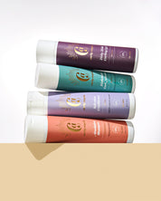 The Curly Angels Strong Hold Set with four bottles vertucally stacked on a beige background including Absolution Shampoo, Salvation Shampoo, Conditioner, Hallelujah Curl Activator, and Holy Hold Curling gel. All products are vegan, paraben-free, sulphate free and suitable for all curl types