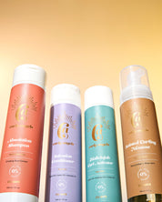 The Curly Angels Weightless Set with four bottles against a golden backdrop including Absolution Shampoo, Salvation Shampoo, Conditioner, Hallelujah Curl Activator, and Sainted Curling Mousse. All products are vegan, paraben-free, sulphate free and suitable for all curl types